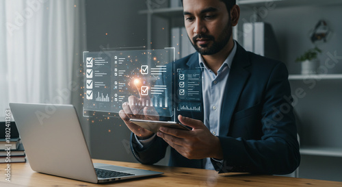 Professional businessman analyzing financial data on futuristic holographic interface, driving modern business decisions with digital insights.