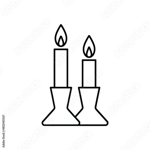 Two lit candles in simple holders