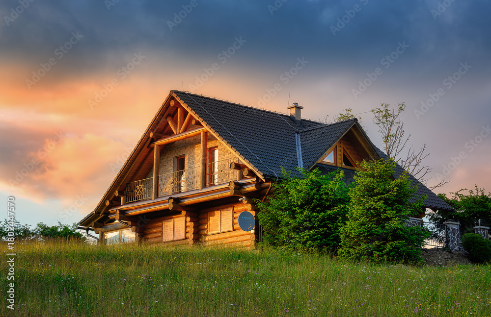 Obraz premium view of a wooden cottage above the village of Oravska Lesna