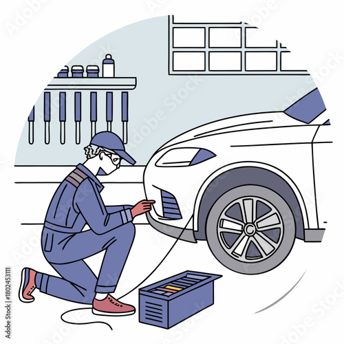 Mechanic inspecting car bumper with diagnostic tool