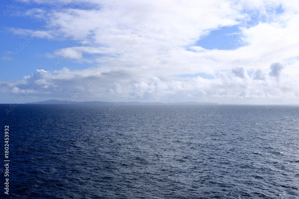 Obraz premium A distant view to the north coast of the Shetland Islands (Unst island, Muckle Flugga Lighthouse), Scotland