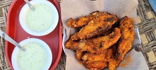 Delicious fried fish served on a colourful table, representing authentic coastal cuisine and traditional flavours of Pakistan. Delicious fish steak slices on a plate. Beautiful 4K Footage.
