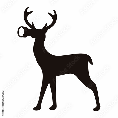 Silhouette of a standing deer holding an object in its mouth