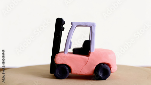Minimalist clay forklift silhouette with copy space on neutral background showing small pink and black model