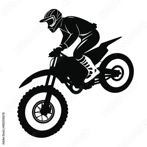 Silhouette of a motocross rider on a motorcycle performing an extreme stunt