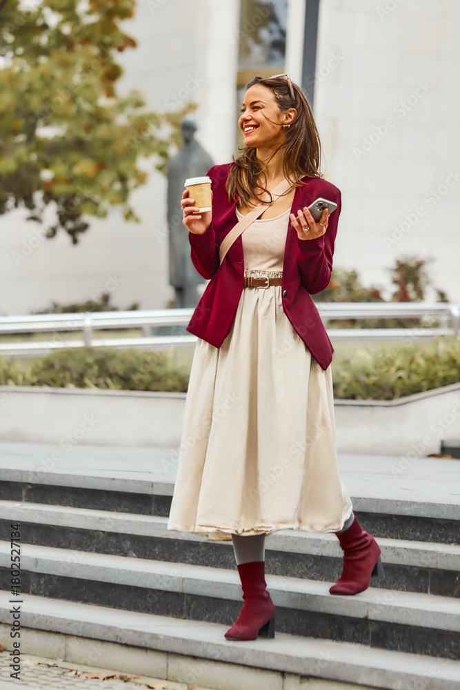 Fototapeta premium Business woman using her mobile phone outdoors.