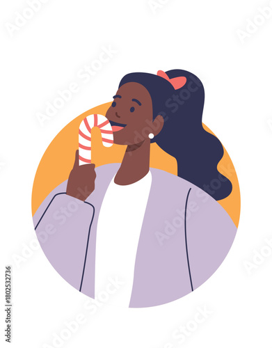 Young woman licking candy cane