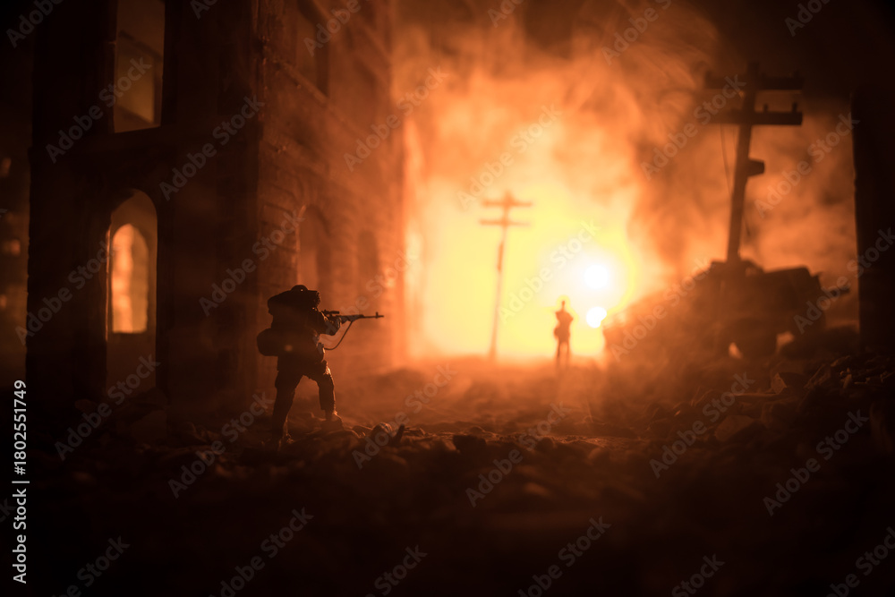 Obraz premium War Concept. Battle scene on war fog sky background, Fighting silhouettes Below Cloudy Skyline at night. City destroyed by war