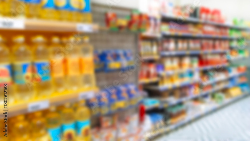 Blur supermarket background. Defocused shelves with products. Grocery store. Retail industry. Discount. Inflation concept. Aisle. CPG. Rack. Tariff reprieve. Price hikes. Bottles of sunflower oil.