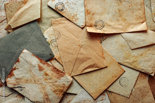 фотографія Collection of vintage envelopes in antique with weathered edges piled together