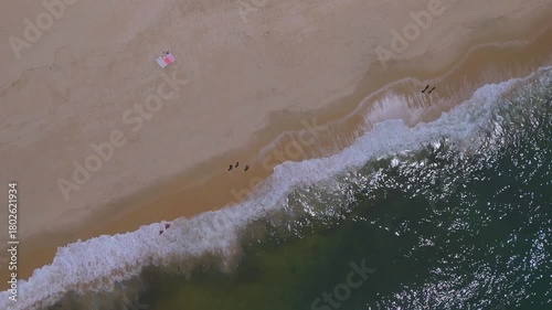 Aerial top view footage of the beach of Figueira da Foz, It is a coastal city with several beaches, summer and seaport facilities on the Atlantic Ocean coast.