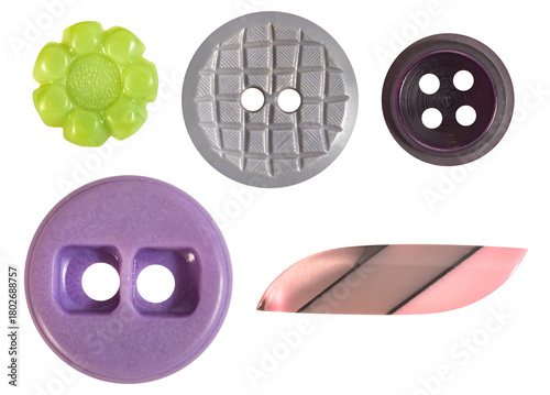 Isolated photo of various shaped and colored plastic decorative cloth buttons on white background.