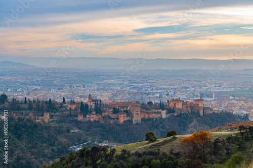 Panoramic view of Alhambra palace or fortress complex at sunset, Granada, Andalusia, Spain. Islamic architecture. UNESCO World Heritage Site. Travel photography