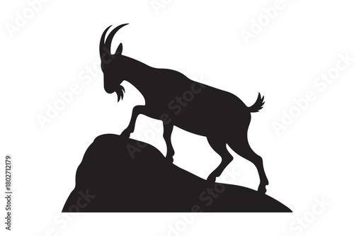 Silhouette of a mountain goat standing on a rocky outcrop