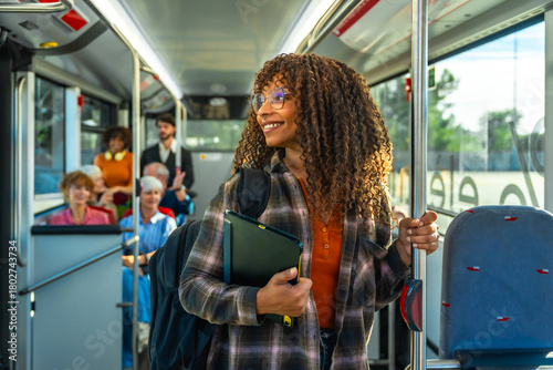 Obraz na plátne Young woman commuting on bus with diverse passengers