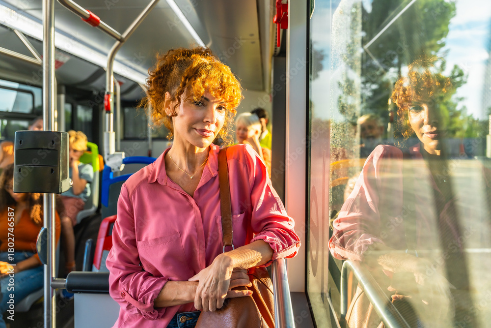 Obraz premium Redhead woman commuting on public transport bus