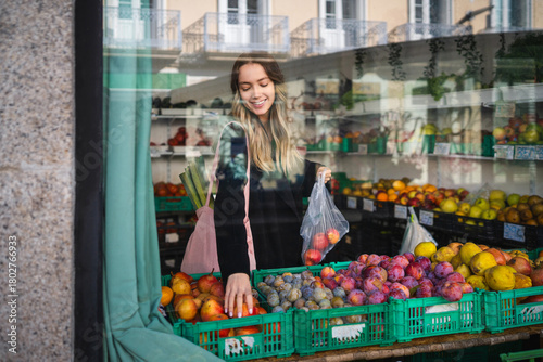 Woman buying fresh fruit at local market