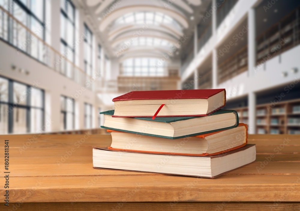 Fototapeta premium stack of school reading books on wooden table in library