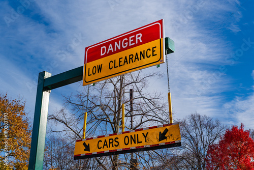 Traffic warning sign stating low clearance on Storrow Drive in Boston where trucks often hit low bridges.