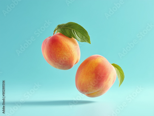Peaches floating against a light blue background showcasing vibrant colors and natural beauty
