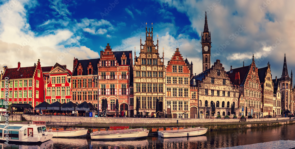Fototapeta premium Ghent city historical center, tourists boats and colorful buildings on Leie river bank, Belgium