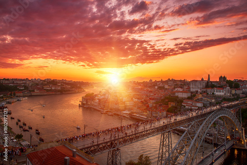 Scenic view of Porto city during sunset with a bridge over the river in Portugal.