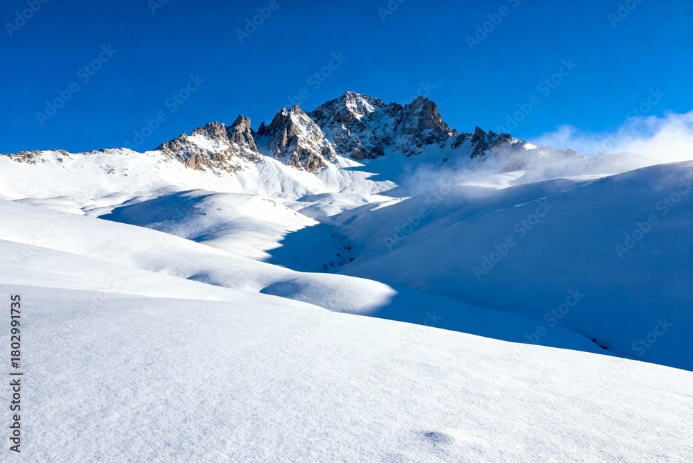 Fototapeta premium Snowy winter mountain landscape with bright blue sky, perfect nature background for travel, winter scenery, outdoor adventure and cold season visuals.