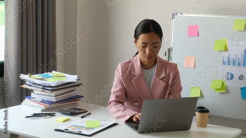 Businesswoman, office worker stressed out from laptop use, overwork, and accounting document errors. Office syndrome concept.