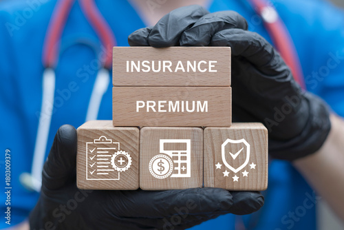 Doctor holding blocks with icons sees the inscription INSURANCE PREMIUM. Health insurance premium medicine service concept. Healthcare medical assurance help money premium healthy web technology.