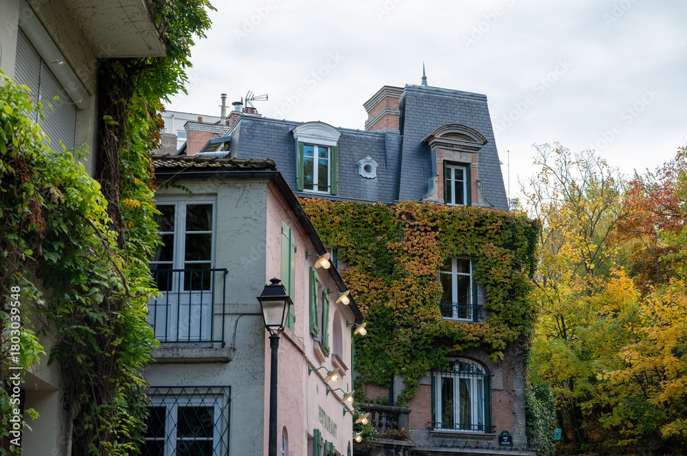 Naklejka premium Walking on Montmartre hilly historical artistic district of Paris with famous buildings and narrow streets, tourists destination in France