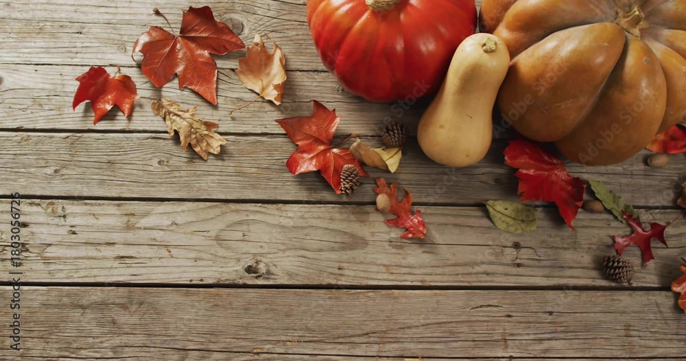 Naklejka premium Sitting pumpkin gourd cluster on right of aged wooden planks, leaves and acorns, copy space