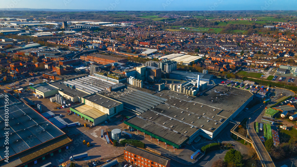 Fototapeta premium Massive industrial factory complex near urban residential area