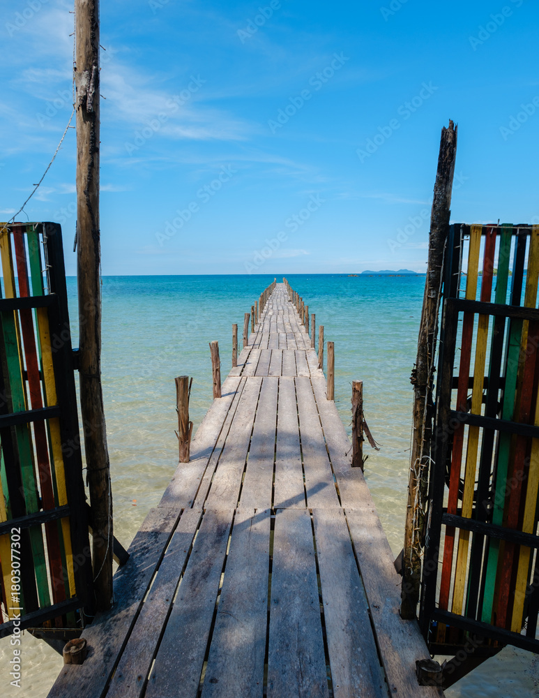 Fototapeta premium Stunning wooden pier leading to the turquoise waters of Koh Kood Island, Thailand