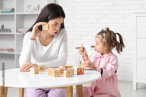 Female teacher with cubes a...