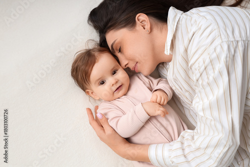 Young mother hugging her ba...