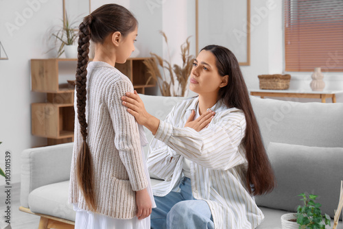Mother apologizing to her daughter at home