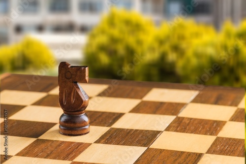 Wooden chess figures on a classic chessboard