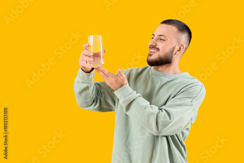 Young man with glass of wat...