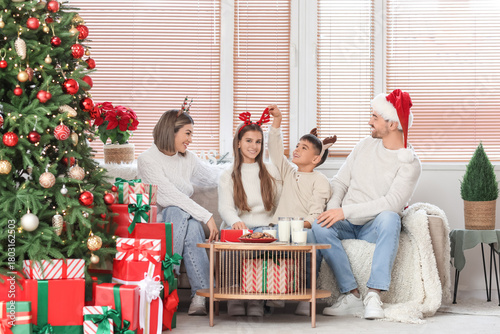 Happy family on sofa celebr...