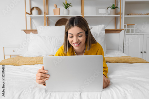 Smiling young woman using l...