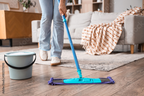 Woman mopping floor in livi...