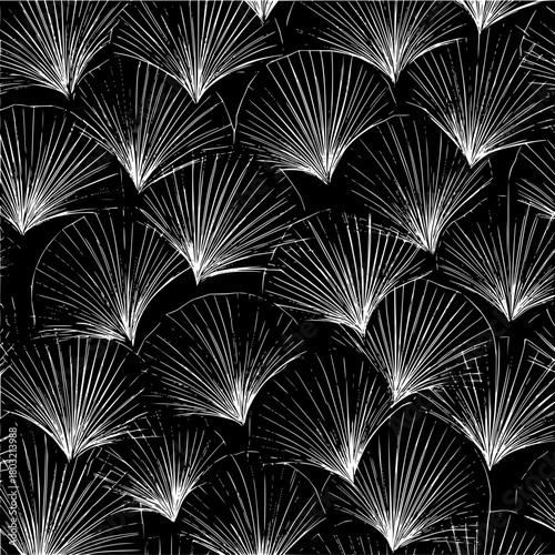 Repeating pattern of white fan shapes on a black background creating a textured and decorative design