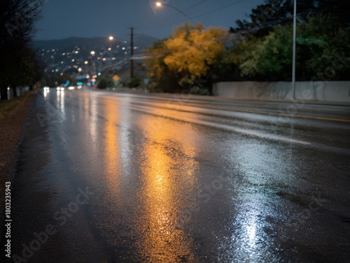 Wet road with a yellowish tint and a reflection of lights on it