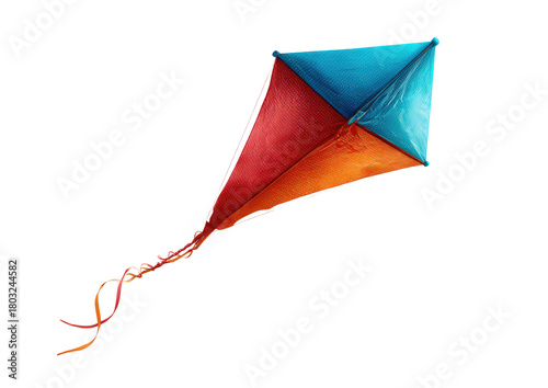 Colorful kite, turquoise, red, and orange, floating in dark