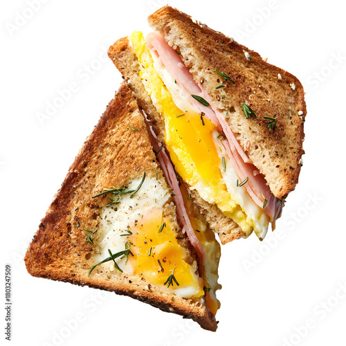 Gourmet ham and egg sandwich with egg-in-a-hole toast. Delicious breakfast or brunch concept, isolated on a black background.