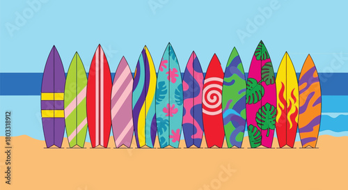 Vibrant surfboards lined up on sandy beach with ocean backdrop
