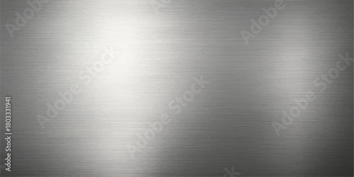 A brushed stainless steel metal texture background or plate with a shiny metallic silver surface and industrial light reflection