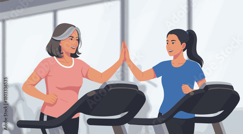 Happy senior woman and young woman giving a high five while exercising on treadmills, embodying fitness motivation and support
