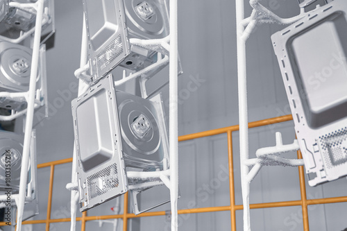 Microwave oven casings in washing stage at powder coating workshop