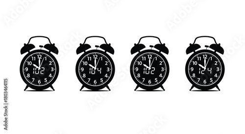 Four black alarm clocks showing different times